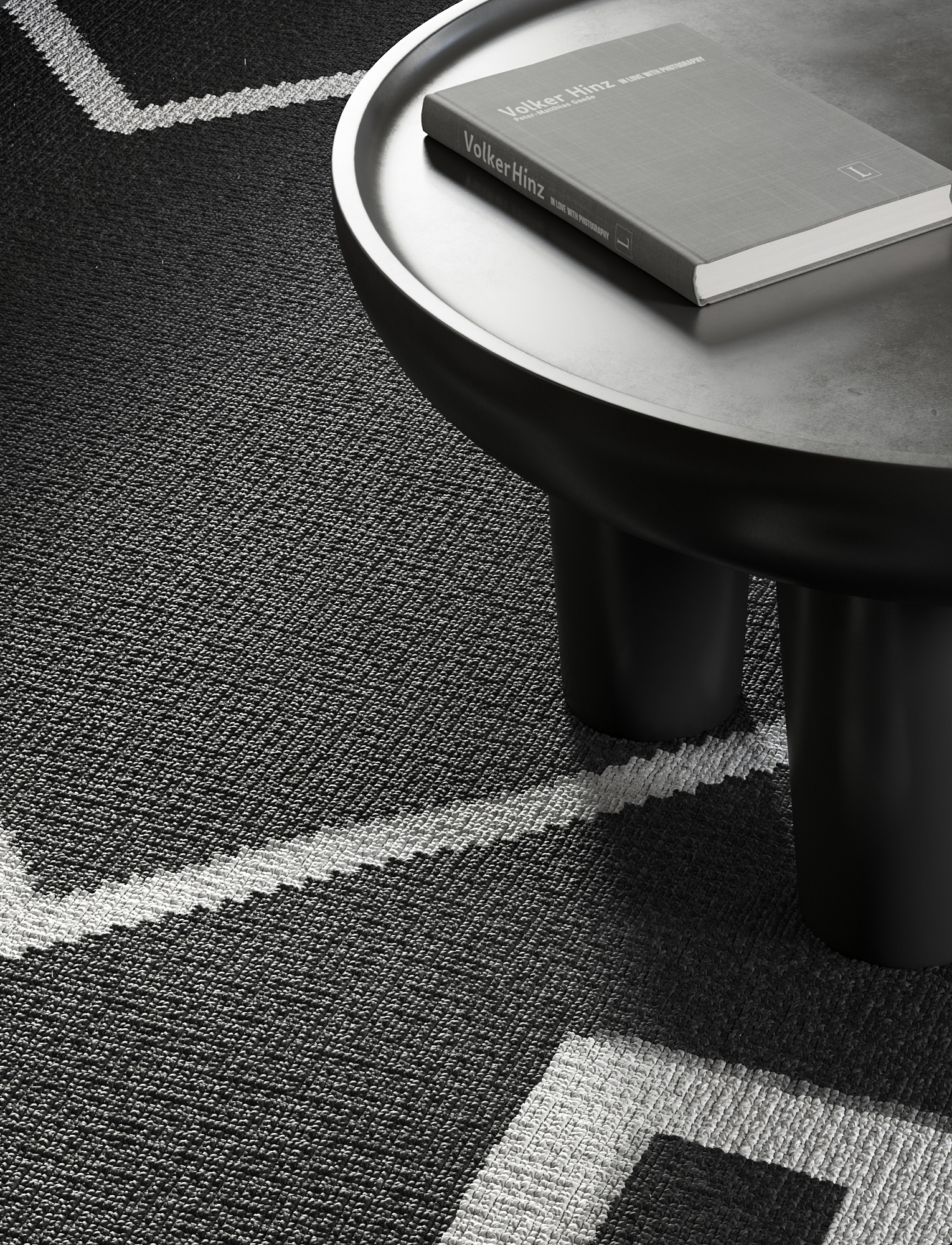 Black coffee table with a book on a patterned rug